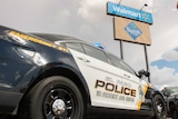 Two police cars parked near a sign reading 'Walmart'