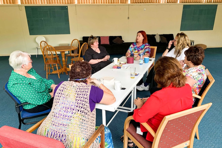 Women chat around a table