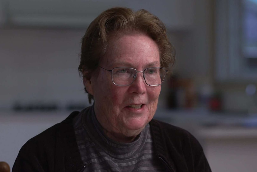 Head shot of Barbara Durham with blurry image of her kitchen in the background