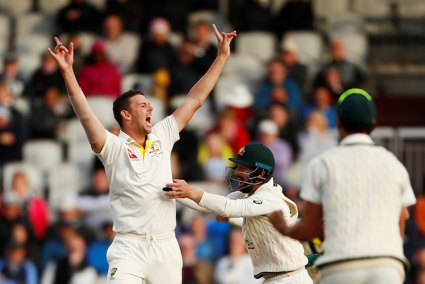 Josh Hazlewood throws his arms in the air to celebrate Australia retaining the Ashes.