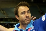 Brad Scott raises his right arm and gives the thumbs up to the Docklands crowd.