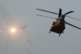 A Chinook helicopter flies over Kandahar City.