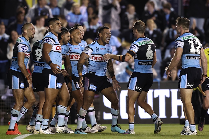 A rugby league team celebrates after winning a match