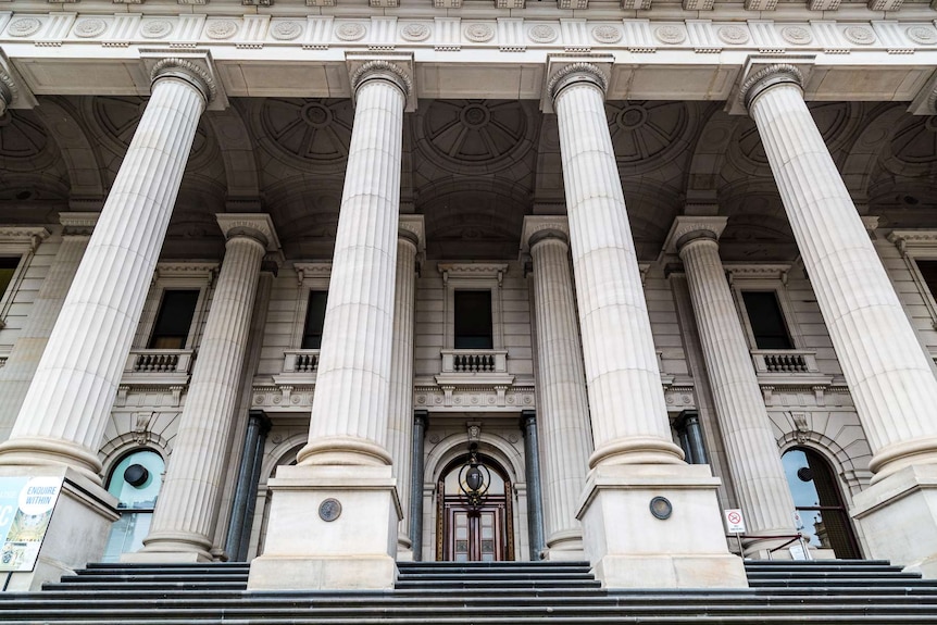 Looking up at the pillars outside the Victorian Parliament.