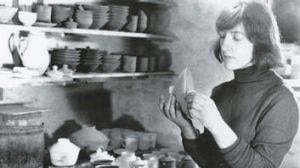 A black and white photograph of Gwyn Hanssen Pigott in a pottery studio
