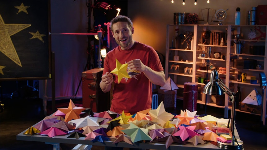 Man holds 3-dimensional star shaped paper figures