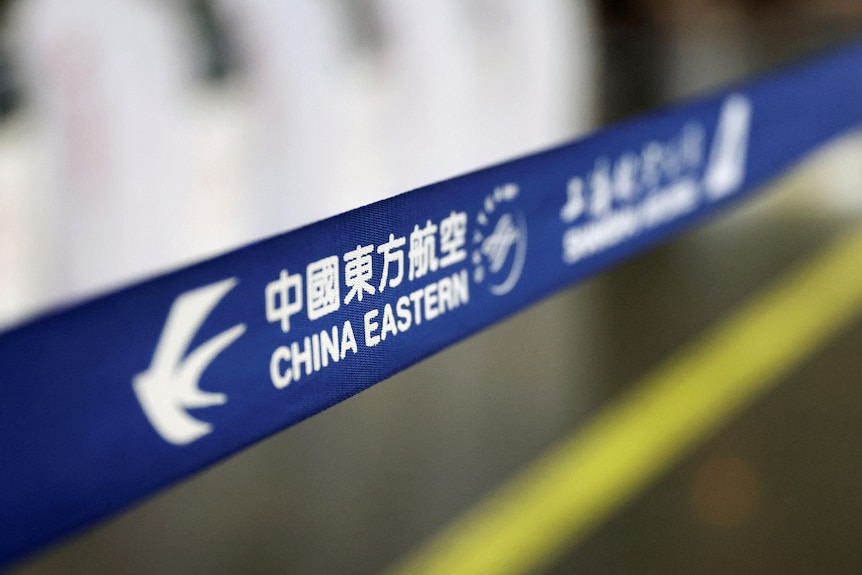 A blue banner at the airport reads China Eastern. 