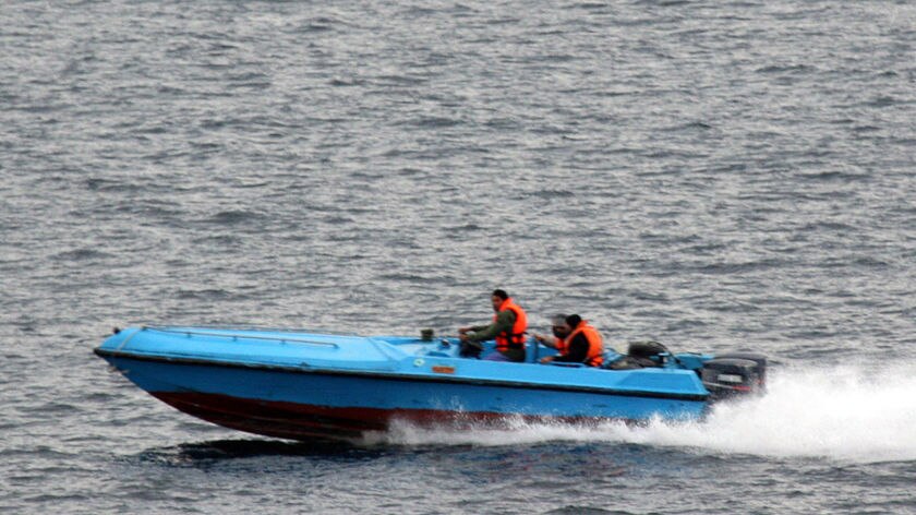 Small craft manoeuvre near US warships