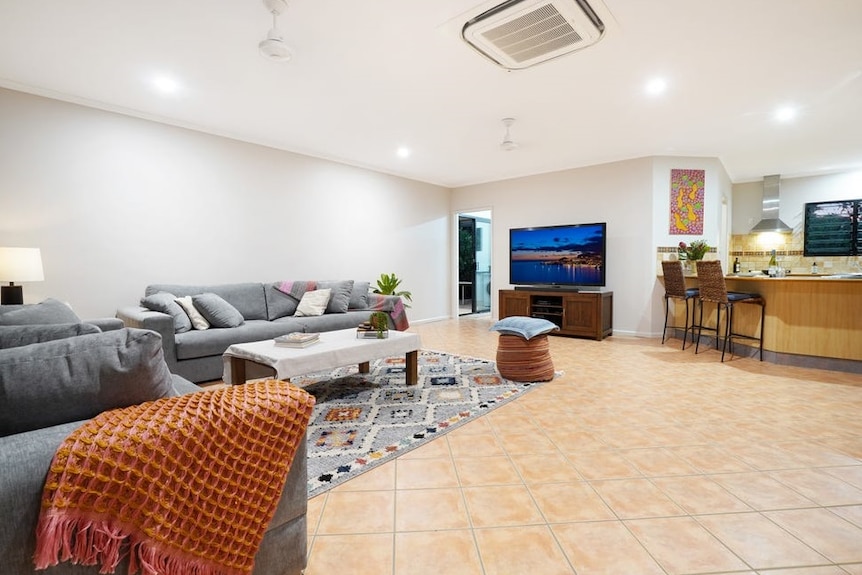 A tiled open-plan kitchen and living area.