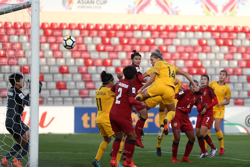 Australian soccer player heads the ball