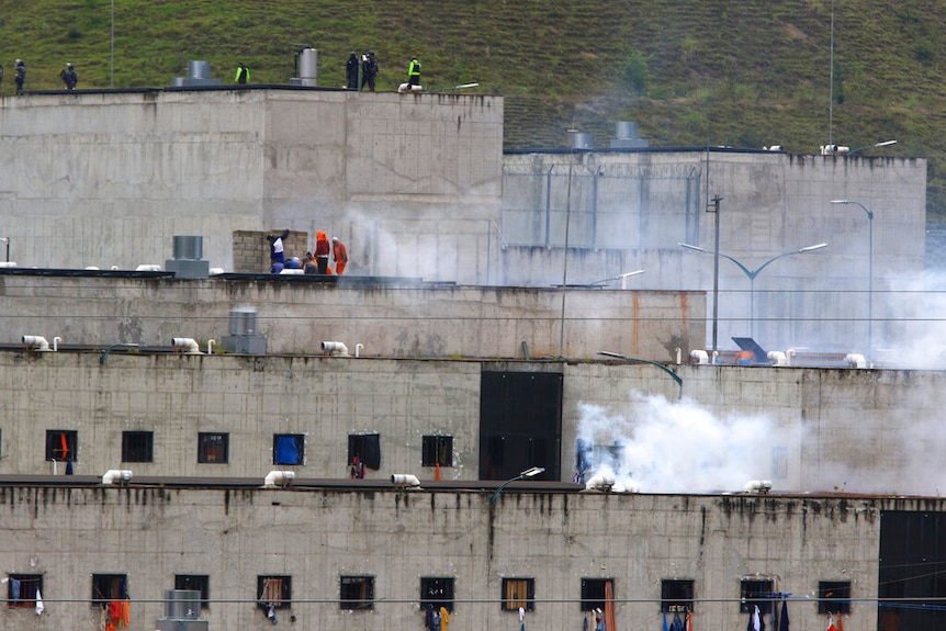 Tear gas rises from parts of Turi jail where an inmate riot broke out in Cuenca, Ecuador,