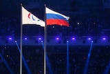 The Paralympic (L) and Russian flags fly at the opening ceremony of the 2014 Sochi Paralympics.
