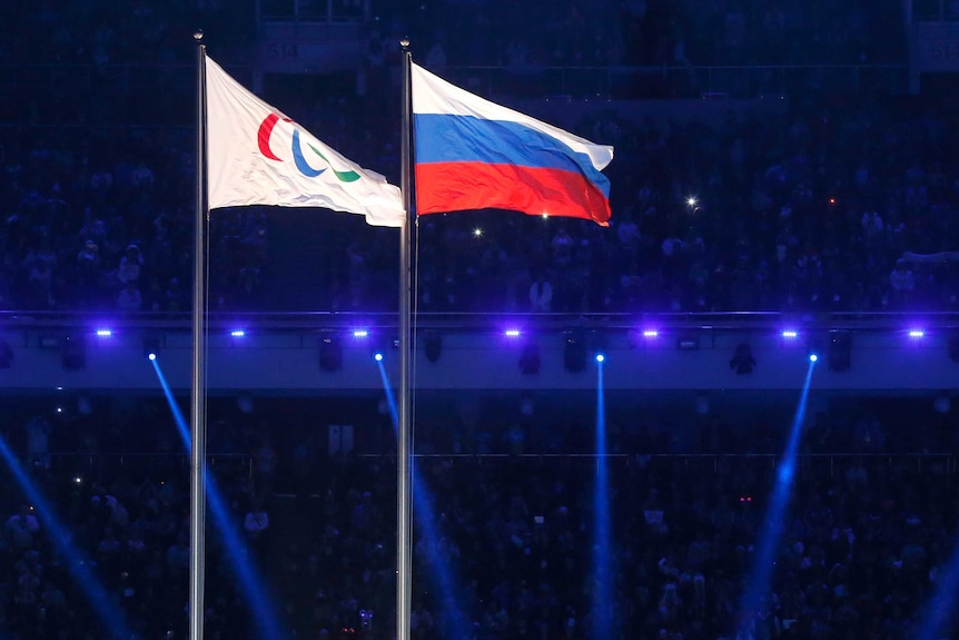 The Paralympic and Russian flags fly side by side at the Sochi Winter Olympics opening ceremony