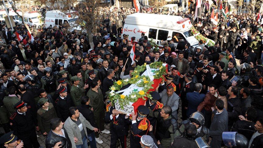 A flag-draped casket being carried into a mosque in Damascus on January 7, 2012