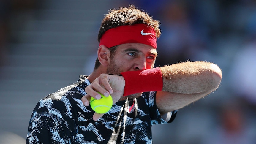 Juan Martin Del Potro of Argentina wipes his face in his quarter final match against Mikhail Kukushkin