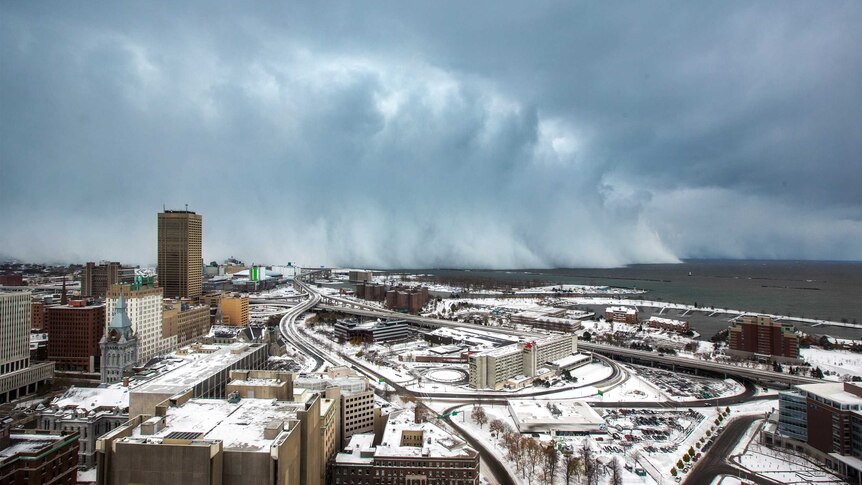 Storm clouds and snow blows off Lake Erie in Buffalo, New York.
