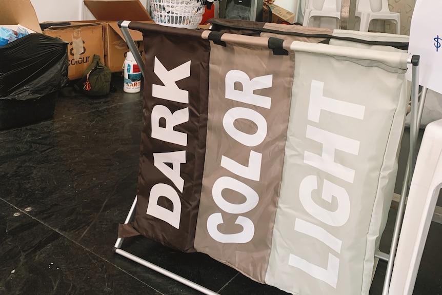 A laundry sorting basket with the words 'dark', 'colour' and 'light'.