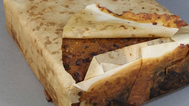 A fruitcake believed to more than 100 years old wrapped in paper.