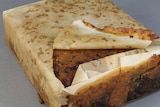 A fruitcake believed to more than 100 years old wrapped in paper.