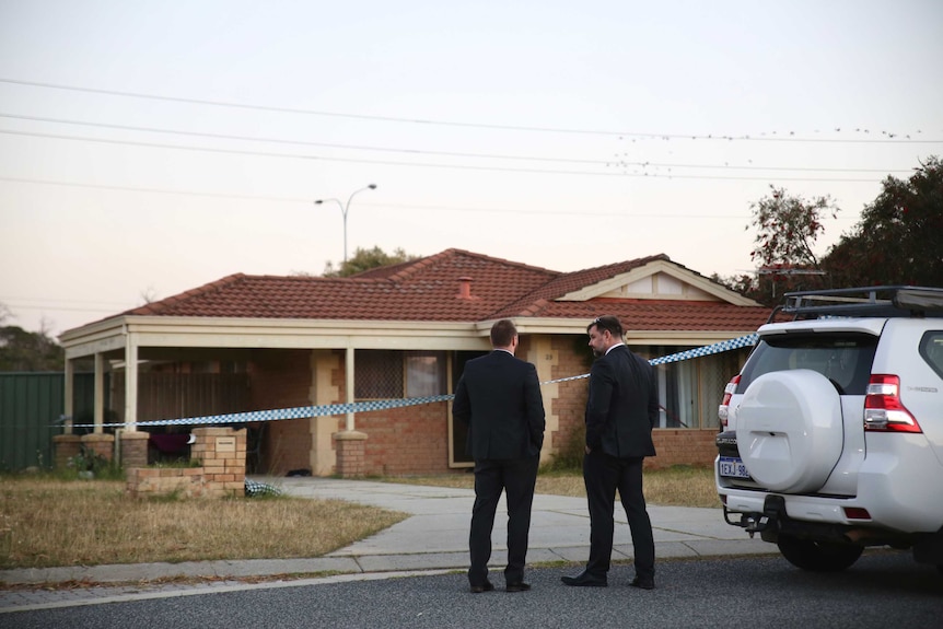 Two WA Police Homicide Squad detectives stand outside a house on Manapouri Meander in Joondalup near a white 4WD.