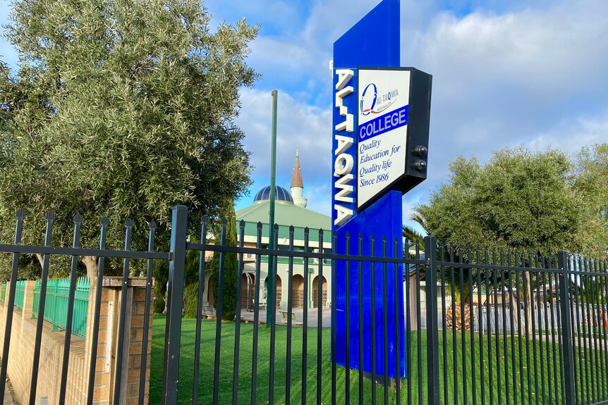 A blue sign outside Al-Taqwa College.