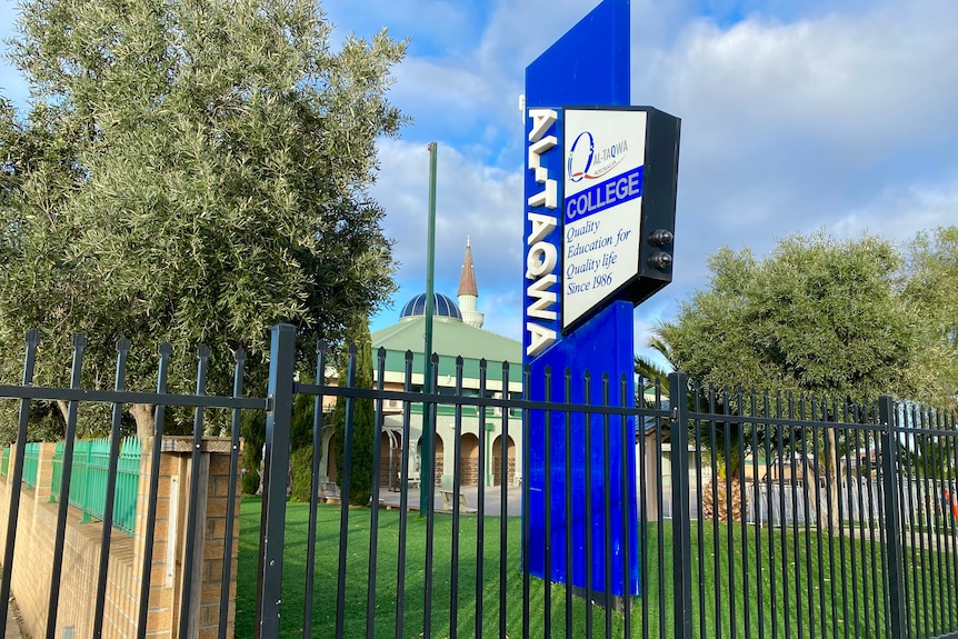 A blue sign outside Al-Taqwa College.