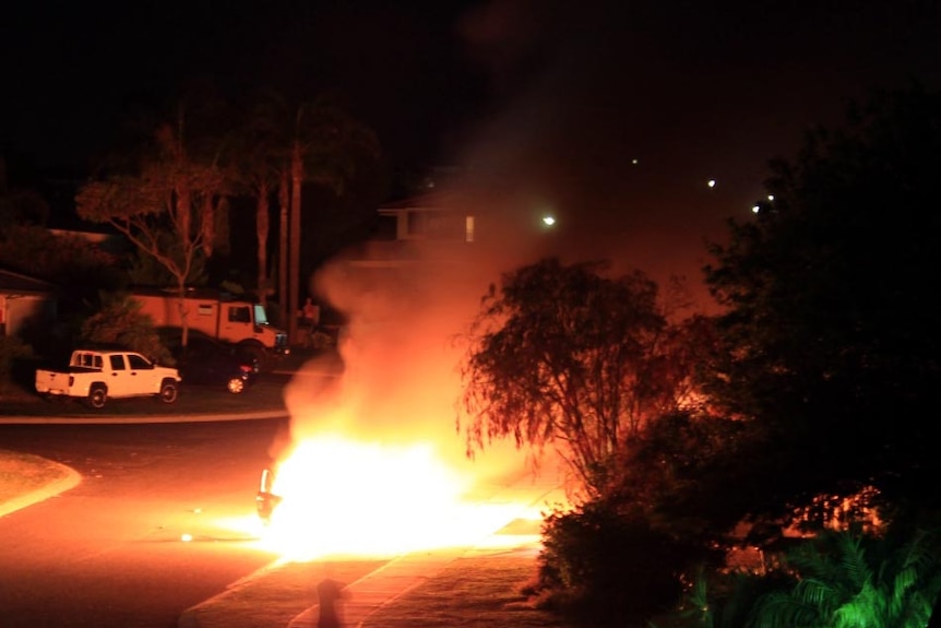 A car allegedly used in the robbery of an ATM burns.