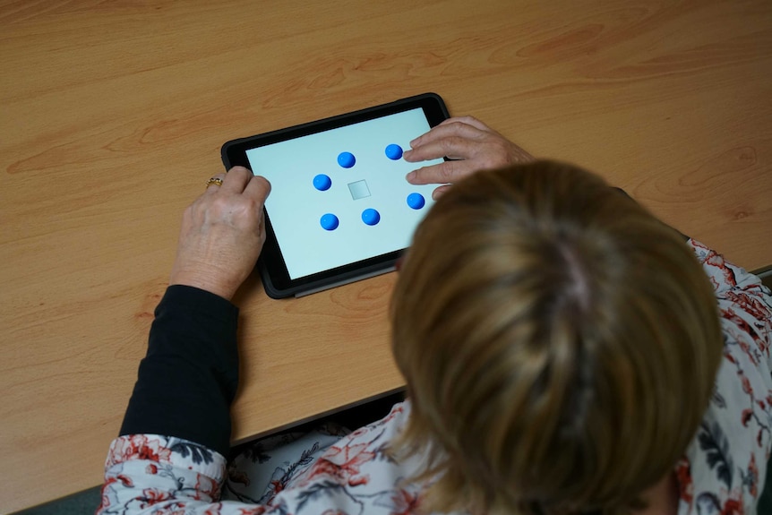 Linda playing memory games as part of her preventative treatment.