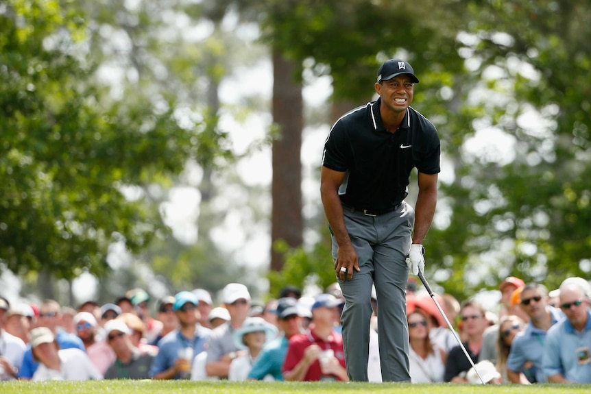 In the hunt ... Tiger Woods watches his tee shot on the fourth hole