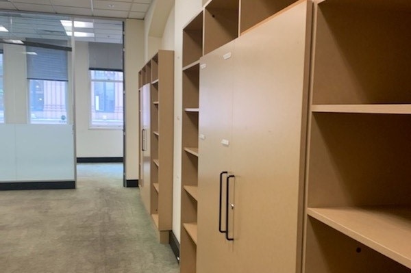 An empty office with empty shelves.