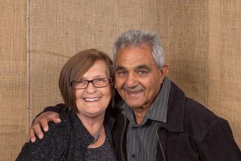 A woman and man smiling for the camera.