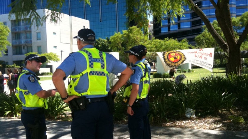 Police outside Perth's Convention centre where protestors gathered as BHP holds its AGM