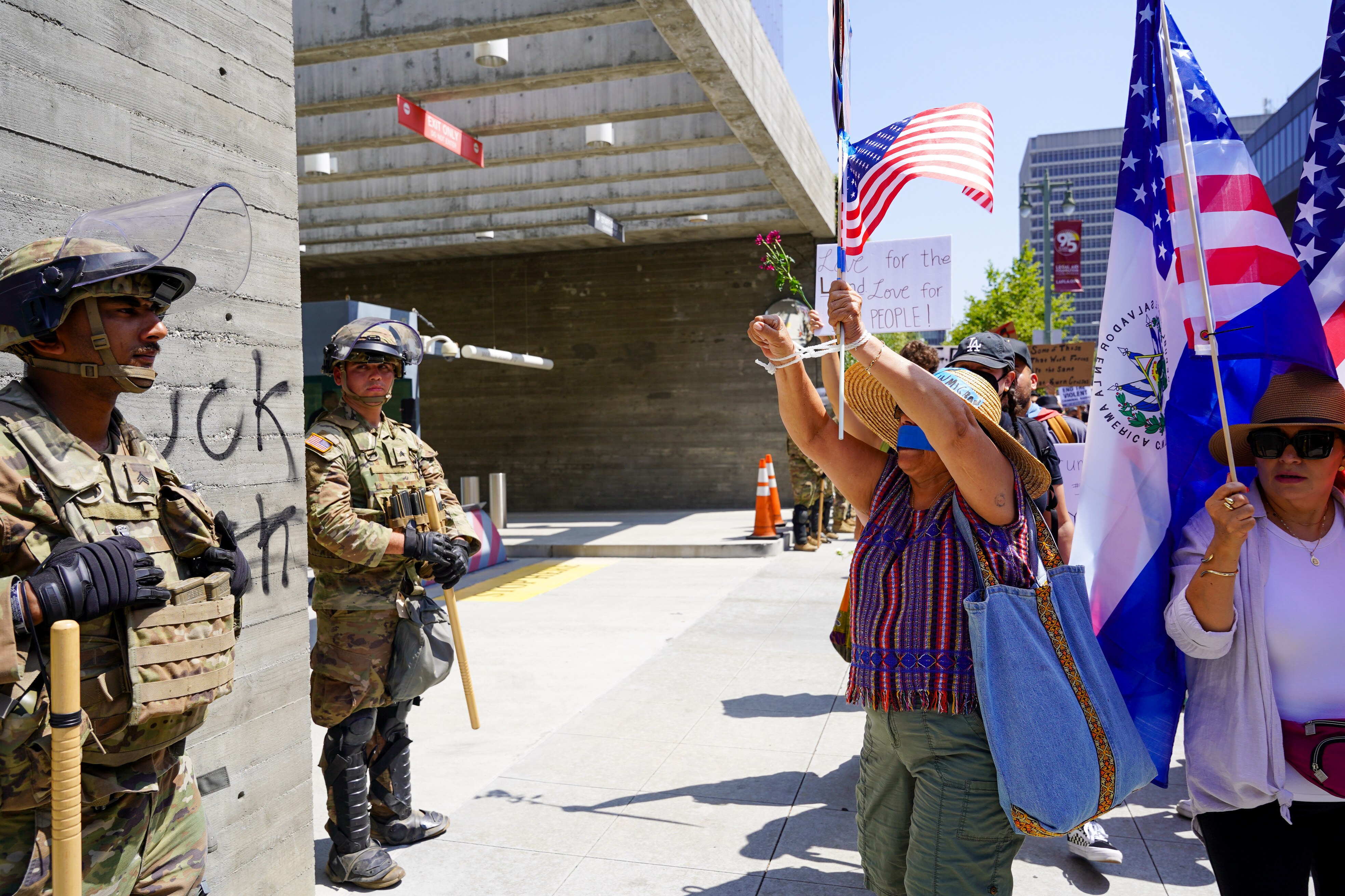 Protesters hold signs in the streets of Los Angeles' downtown area.