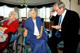 Iona nursing home resident Jessie Serow (centre) chats with Kevin Rudd