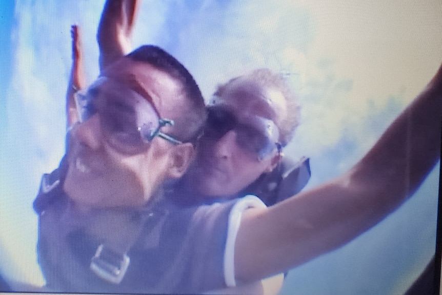 A photo taken in 2006 shows Marley doing his first skydive, smiling as he drops.