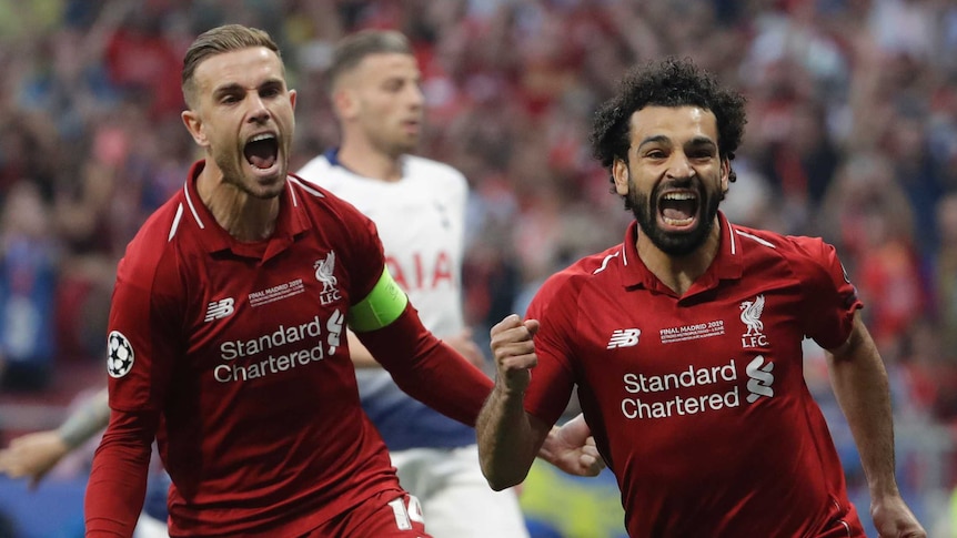 Liverpool's Mohamed Salah, right, celebrates after scoring his side's opening goal
