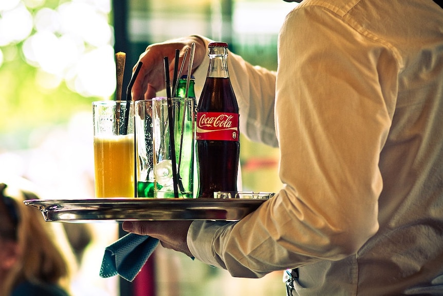 Waiter with a tray of drinks.