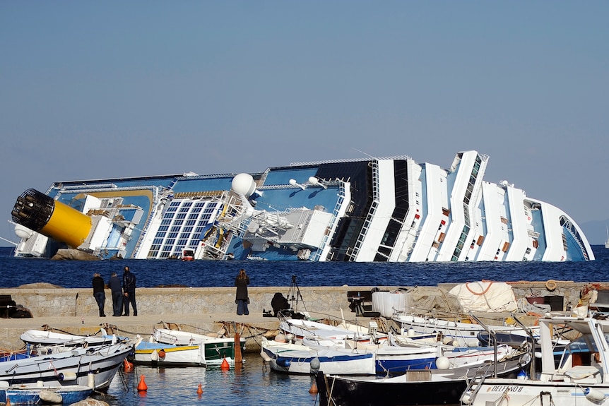 Ships docked behind Costa Concordia