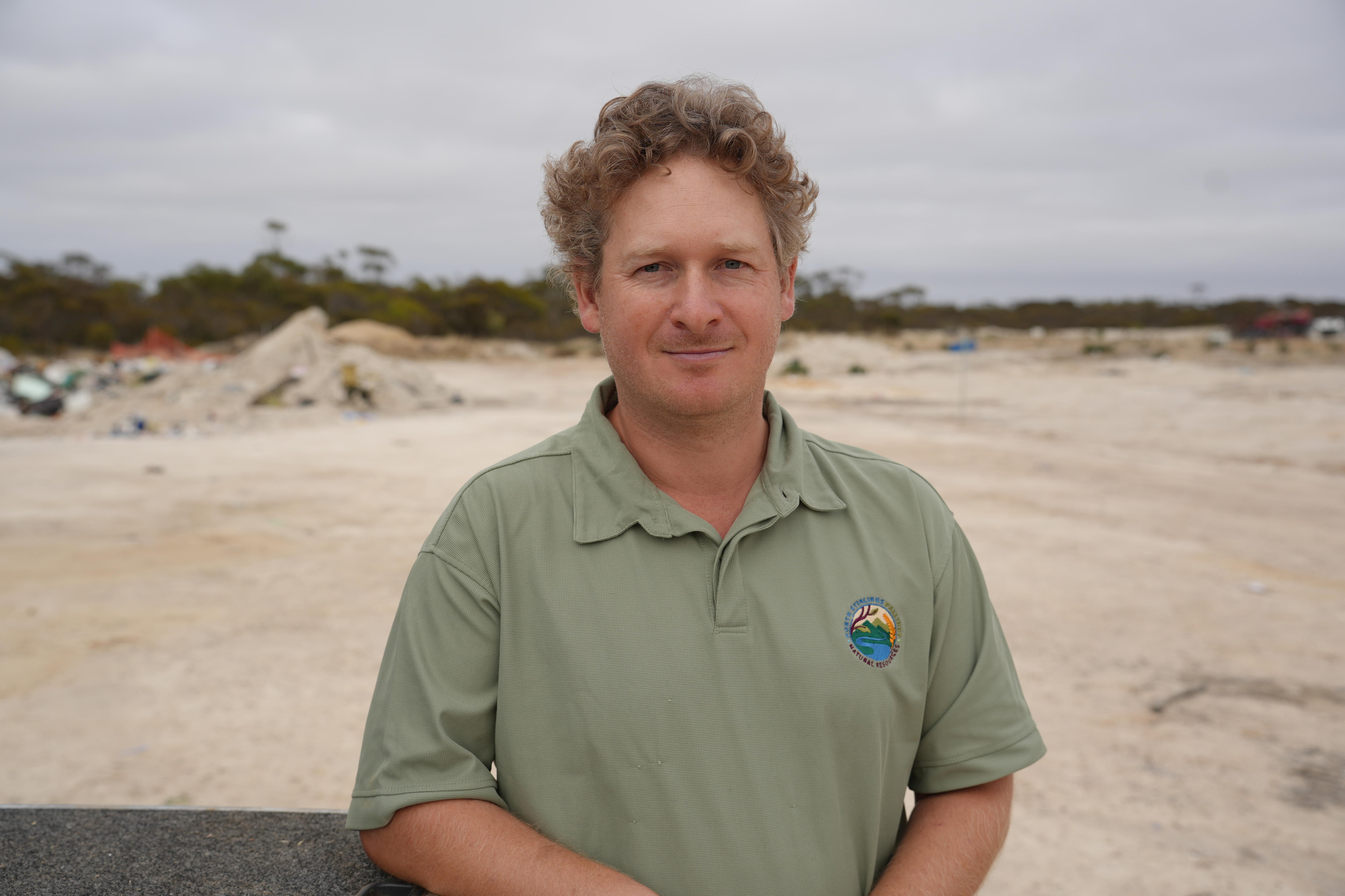 a man in a beige polo shirt 