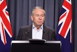 The Premier Colin Barnett standing at a podium.