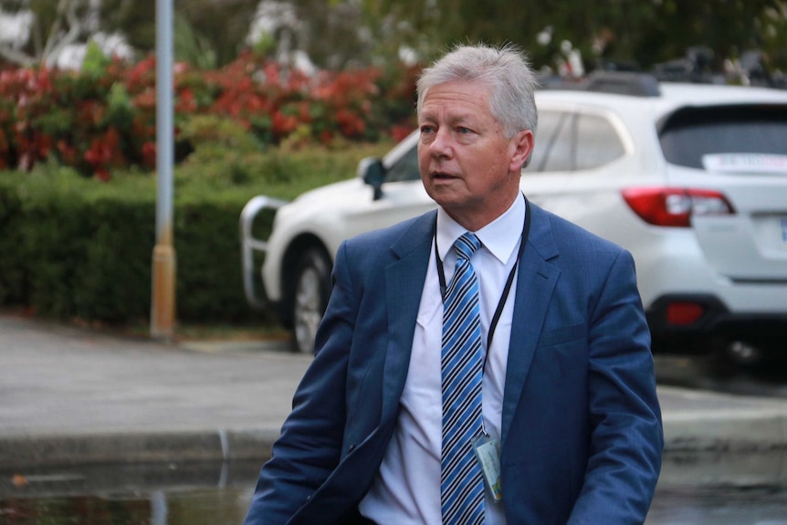 Bill Marmion walks through a carpark