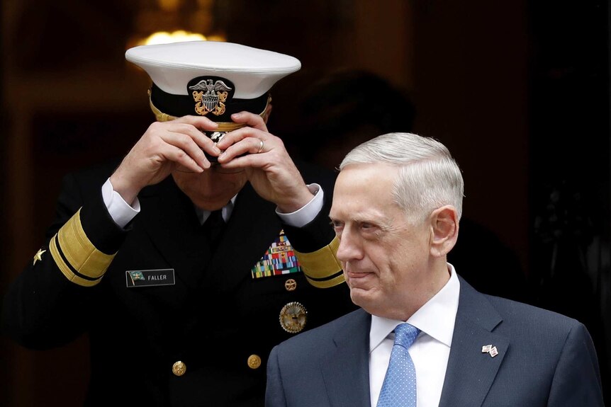 US Defence Secretary James Mattis walks ahead of a US military official outside the British Prime Minister's residence.