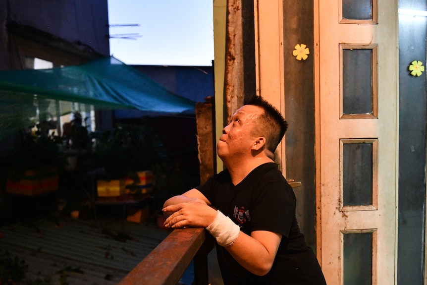 Thien Vu looks out his window at the night sky.
