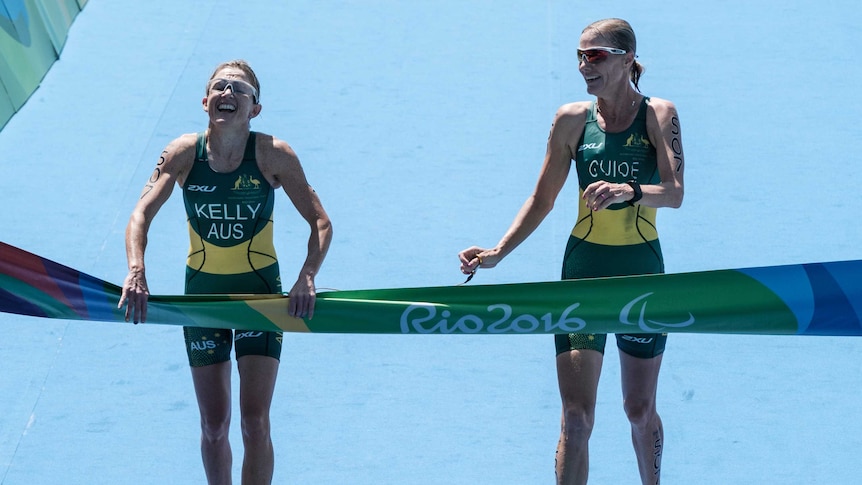 Stunning win ... Katie Kelly (L) crosses the finish line alongside guide Michellie Jones