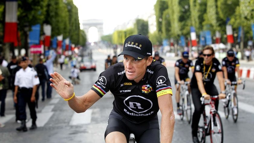Lance Armstrong waves to the crowds in Paris.