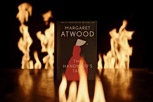 'The Handmaid's Tale' book on a bench surrounded by blames