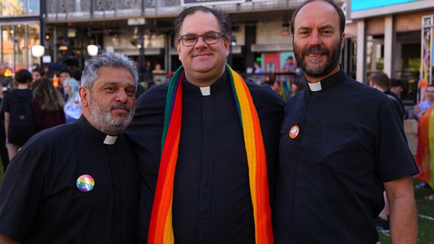 Anglican priest Father Chris Bedding standing with members of Yes lobby group Australian Christians for Marriage Equality.