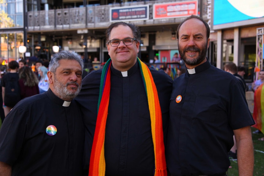 Anglican priest Father Chris Bedding standing with members of Yes lobby group Australian Christians for Marriage Equality.