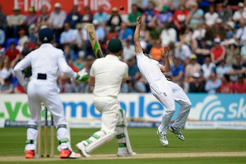 England's Alastair Cook parries a shot from Brad Haddin before catching him on day four in Cardiff.