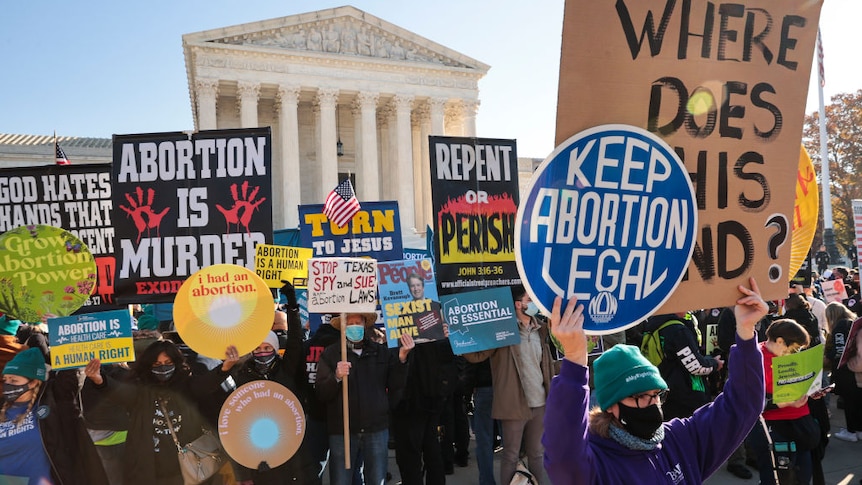 Both pro-choice and anti-abortion protestors gather on the steps of the Supreme Court